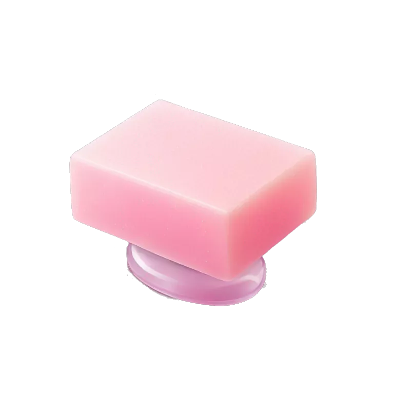 Light pink soap bar sitting on a soap holder, with soap bubbles