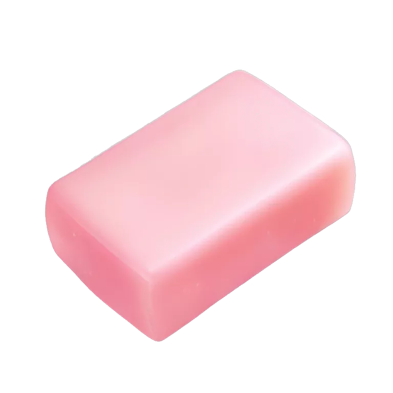 Light pink soap bar sitting on a soap holder, with soap bubbles